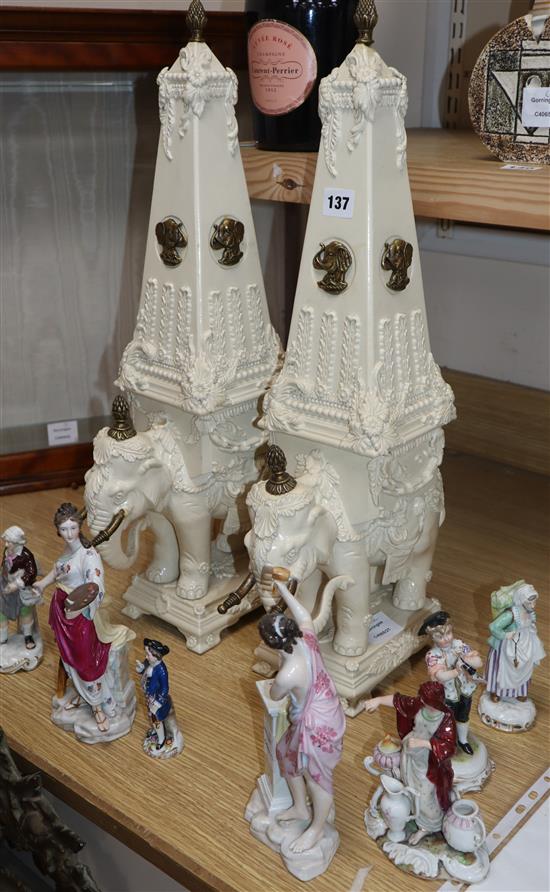 A pair of Wheldon cream decorated pottery models of elephants with obelisk howdahs height 61cm